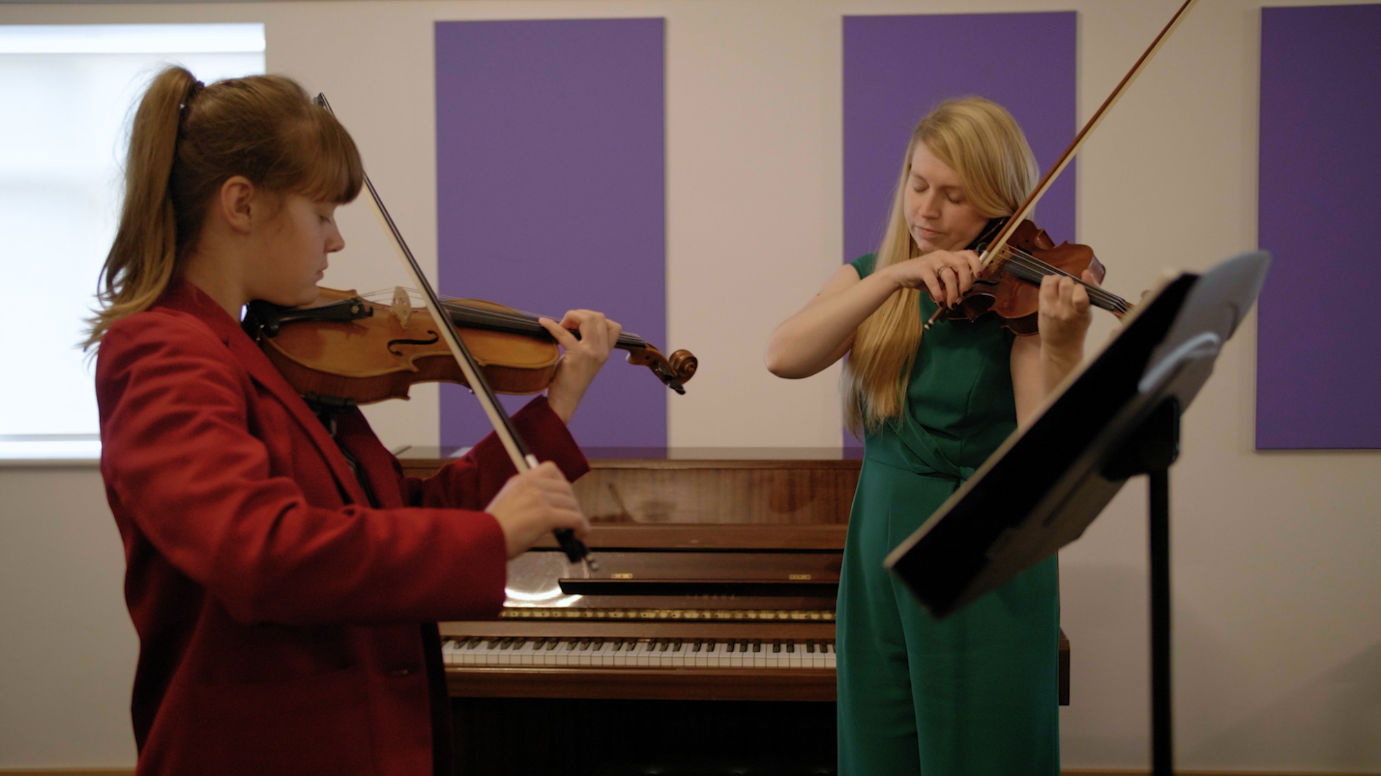 Student receiving 1:1 violin lesson with teacher in music department  