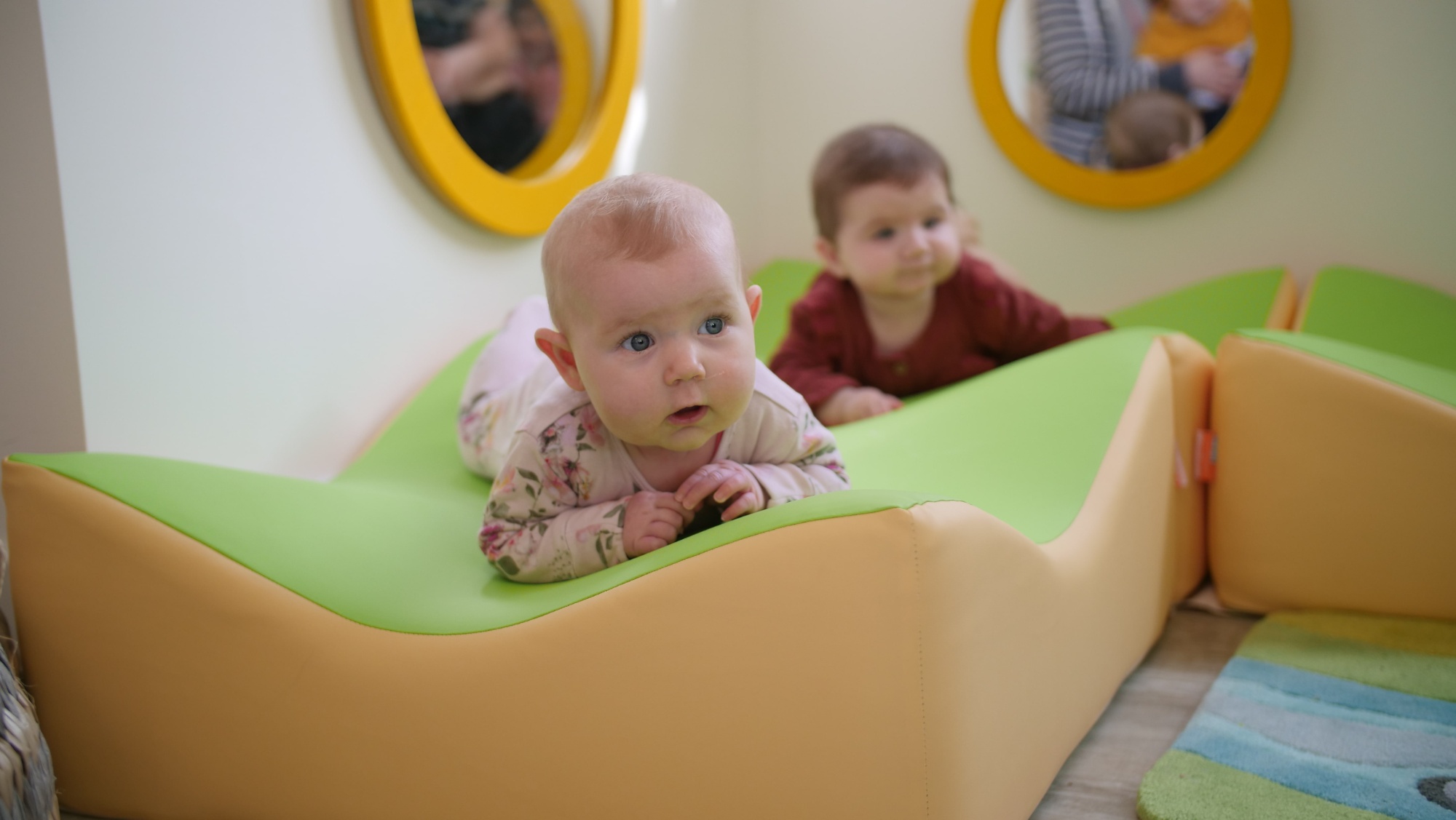 Baby lying on a mat at Lingfield College Nursery