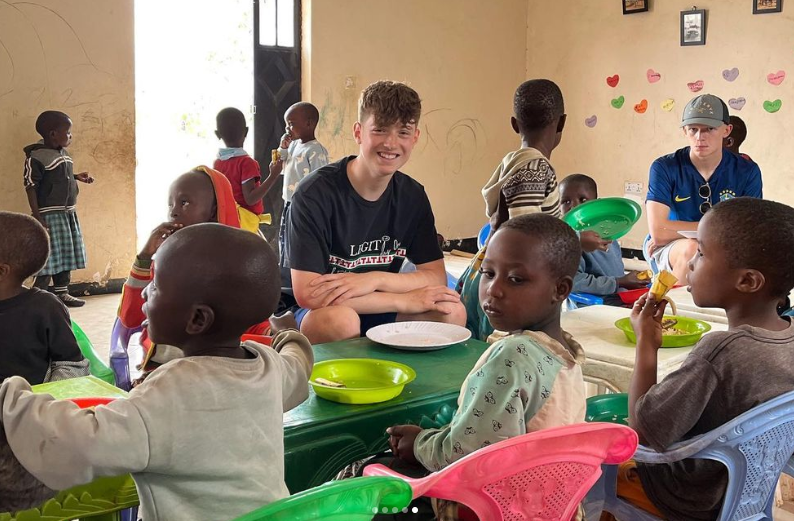 volunteering students with Tanzanian school children