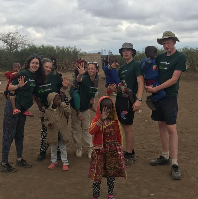 Sixth Form volunteering team and children at Tanzanian school